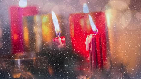 Candles-and-christmas-decoration-combined-with-falling-snow