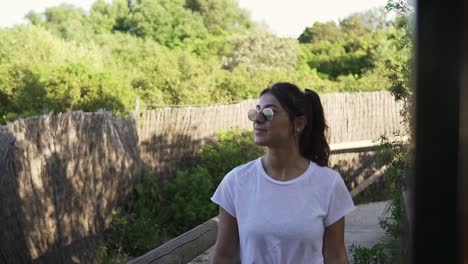 tracking shot of a young model walking along a path