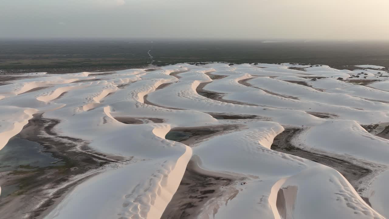 Sunset View Of Fresh Rain Water Lagoons Between Sand Dunes Of Lencois Maranhenses National Park In Brazil. drone sideways shot