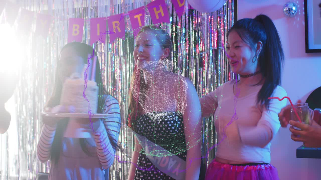 Guest carrying cake to center, birthday guest blowing candles while friends clapping amid fringe