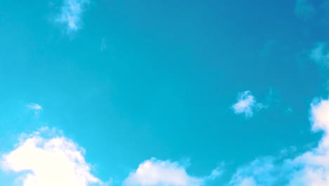 hd hawaii kauai slow motion tilt down from a mostly clear sky to a mostly cloudy sky with a cove and mountainous coastline in distance