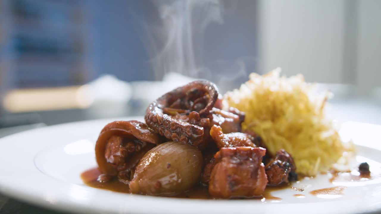 Fricassee octopus with chips freshly cooked served. Handheld shot and close-up