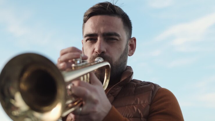 Young Caucasian Man Playing Trumpet Outdoors