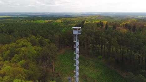 Drone-panorama-view-at-a-fire-lookout-tower-in-the-middle-of-a-wooded-area