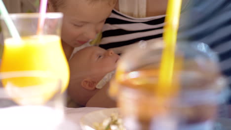 boy expressing love to baby sister with kiss