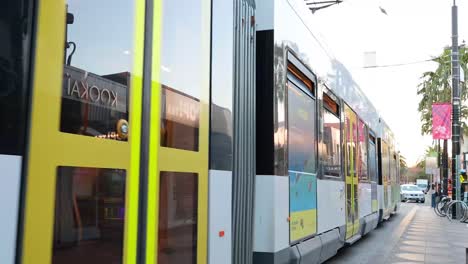 tram moving along street near st kilda pier