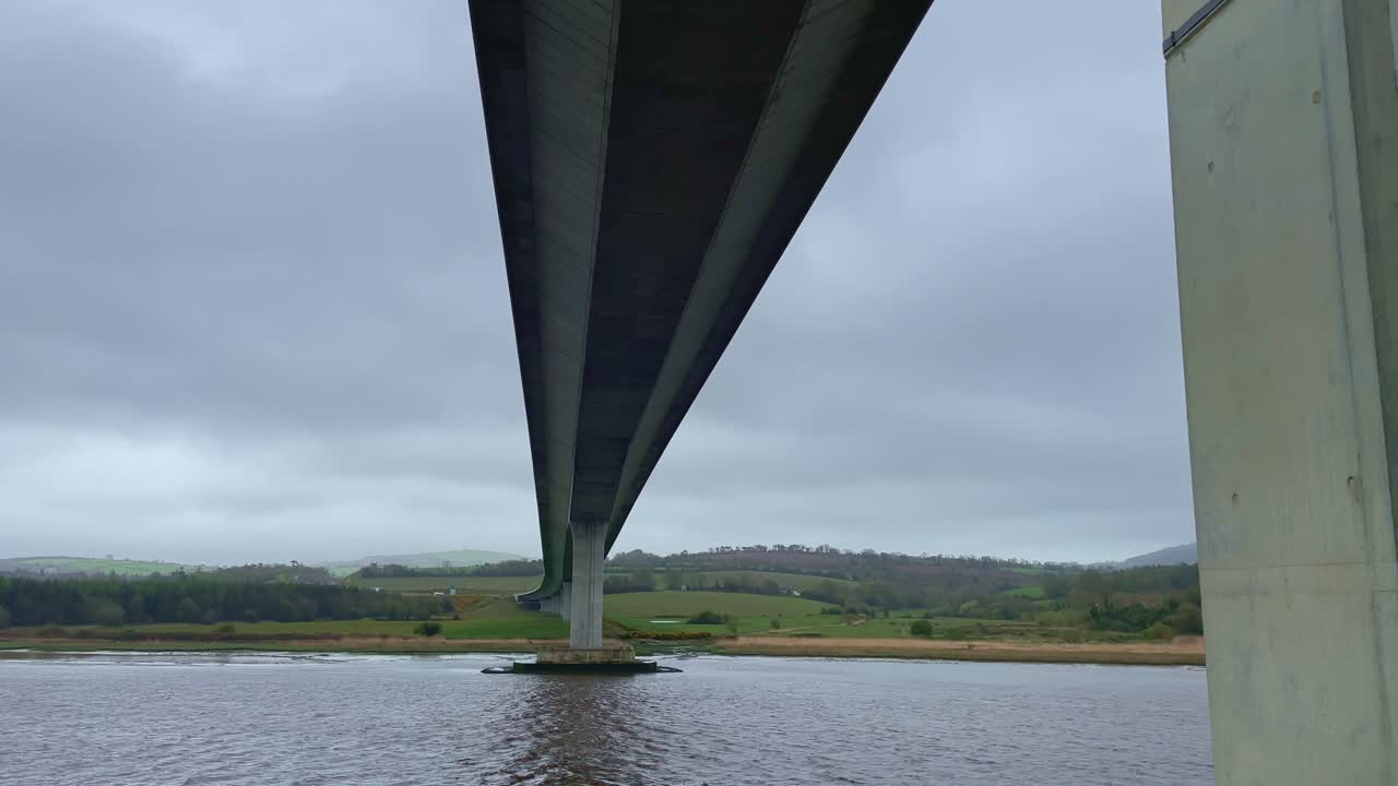 Impressive View of a Long Bridge over a River on an Overcast Day