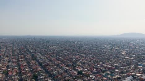 smoggy day in ecatepec, mexico, showing its urban sprawl during an environmental contingency