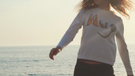 woman walking on the beach at sunset