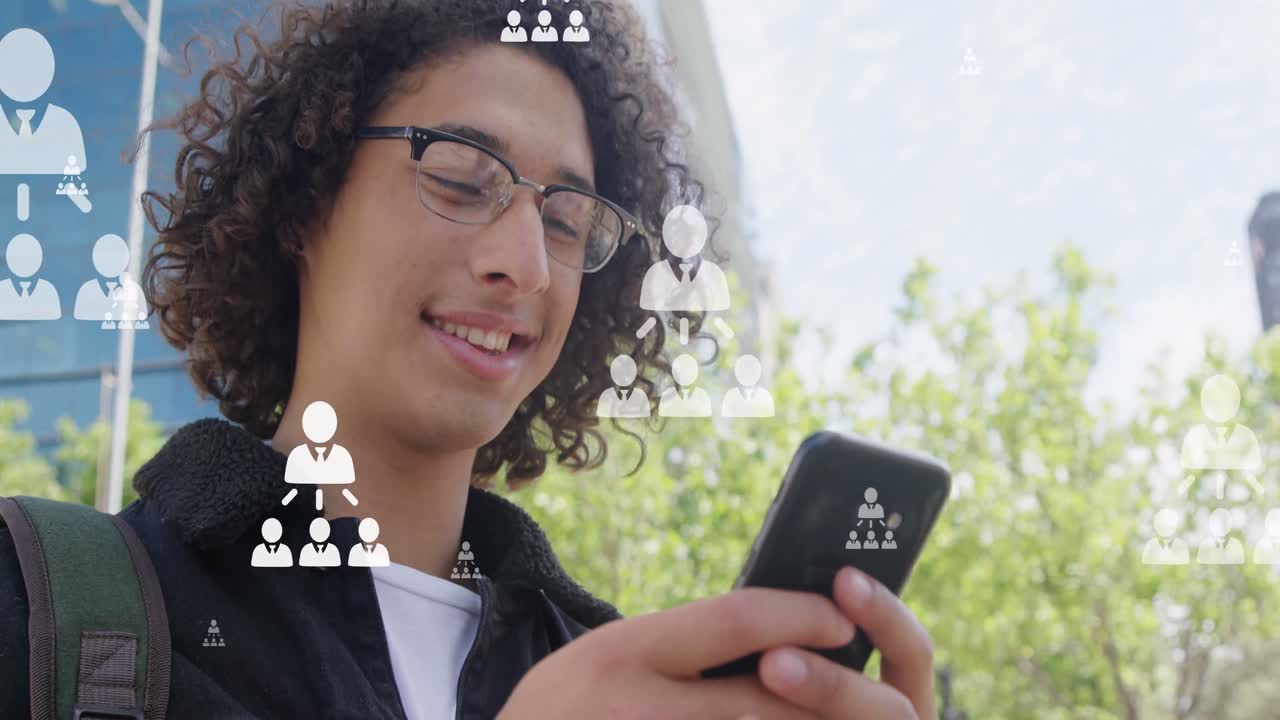 Animation of user icons over happy biracial man using smartphone in city