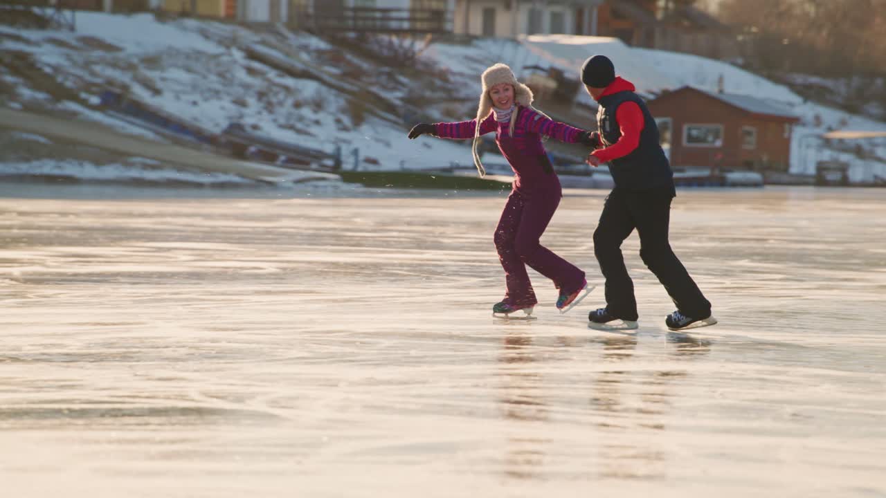 Couple Ice Skating on Frozen Lake in Winter