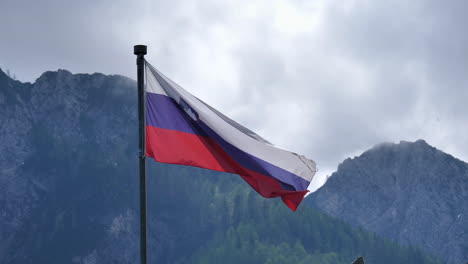 Slovenian-national-flag-waving-in-the-wind-in-Planica,-Slovenia