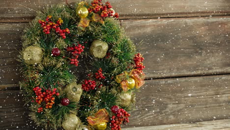 falling snow with christmas wreath