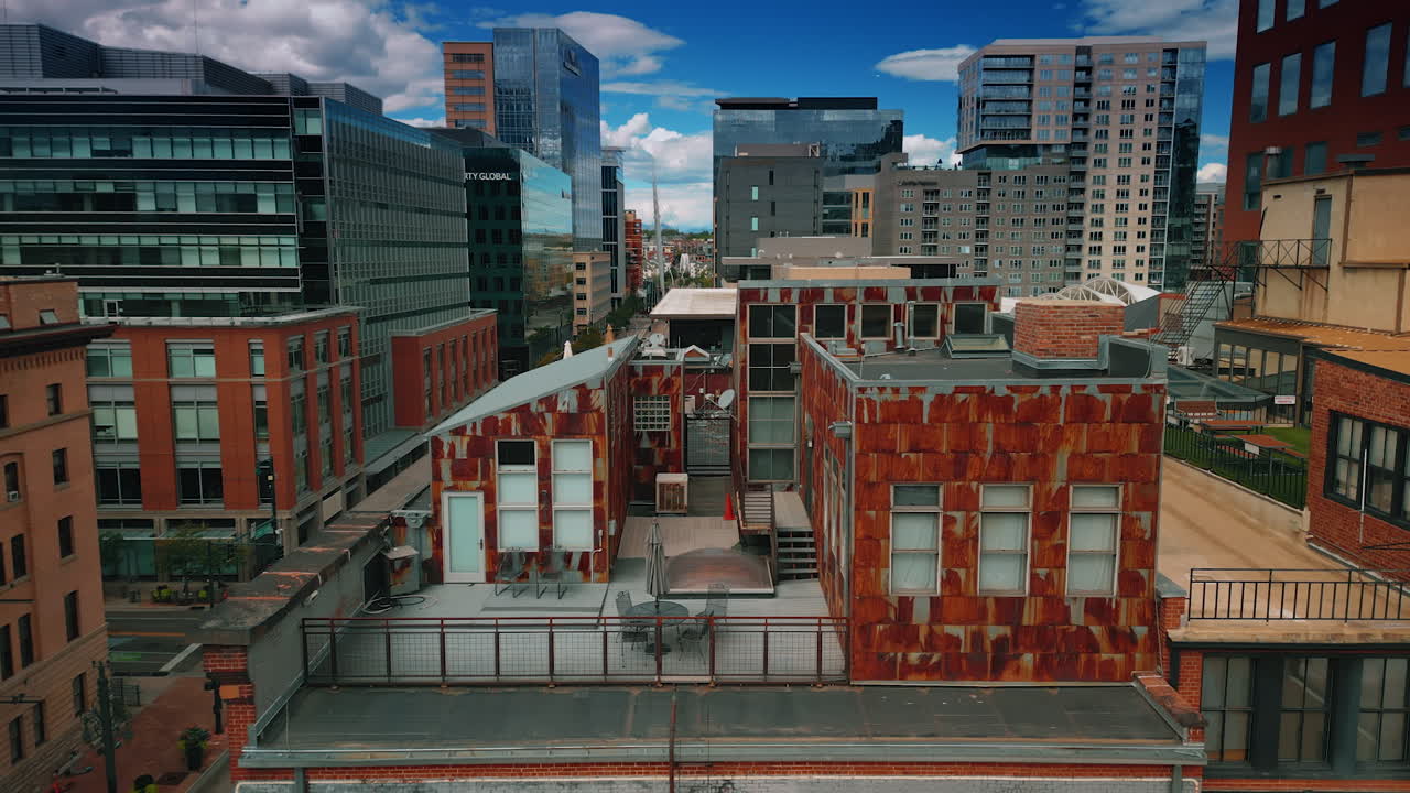 Denver, USA, 24 August 2025: Annex buildings on the top of the high-rise. Brick old-fashioned building with a sign on the façade. Denver, Colorado, USA