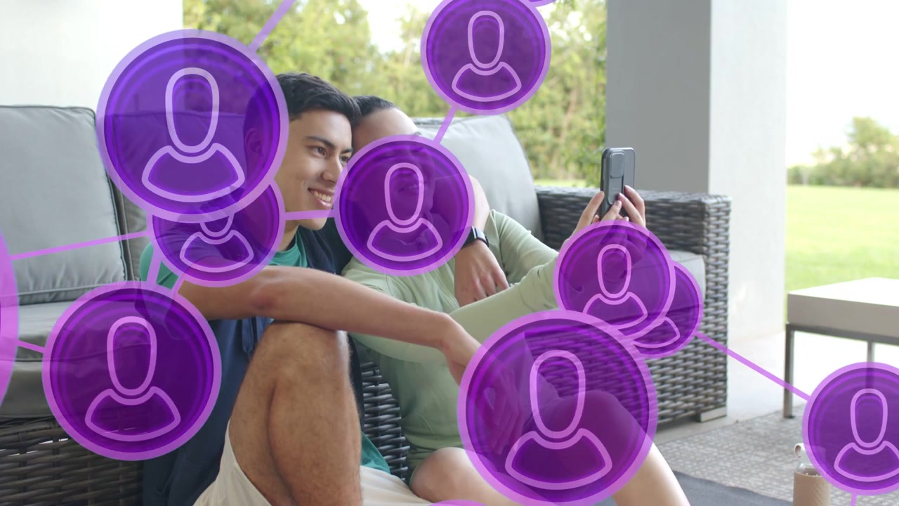 Couple talking on patio purple tech UI appearing woman reaching phone shooting and sharing selfie