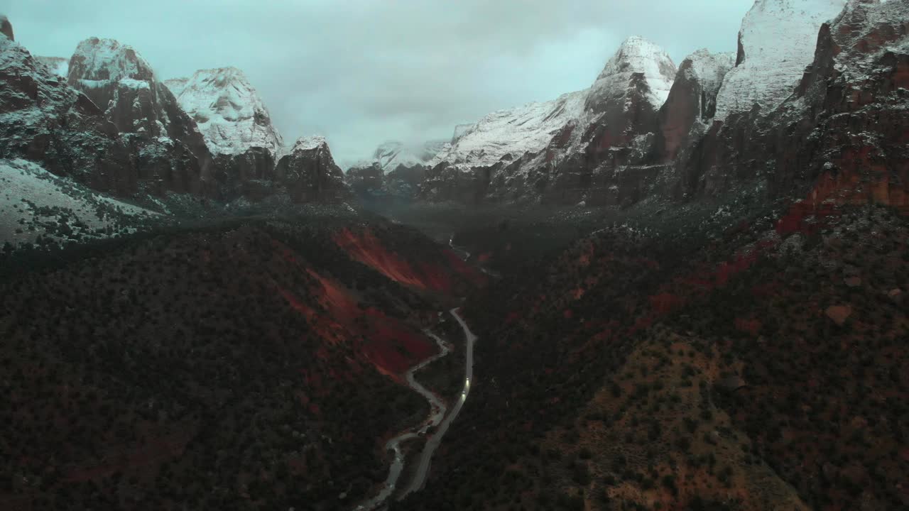 Aerial View of Snow Covered Mountains and Winding Road