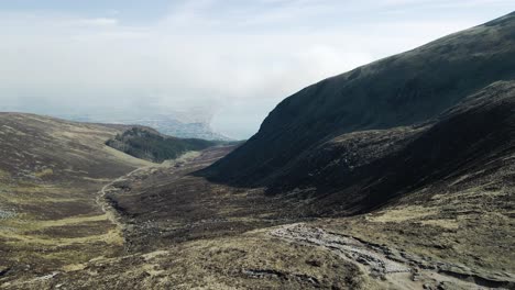 sliding aerial view of mournes valley leading to newcastle town