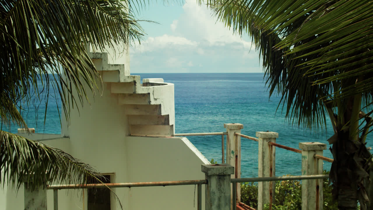Ruins and a view of the Pacific Ocean with waves for surfing in Siargao, Philippines.
