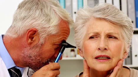 doctor examining his patients ears