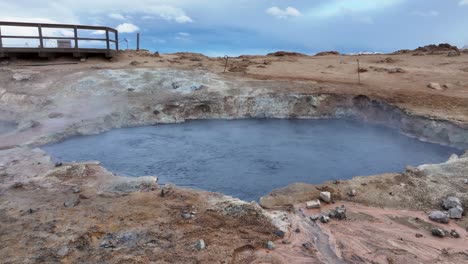 in a jaw-dropping view, the mývatn area, there is a captivating video capturing a small smoking fumarole set against a stunning mountain range backdrop