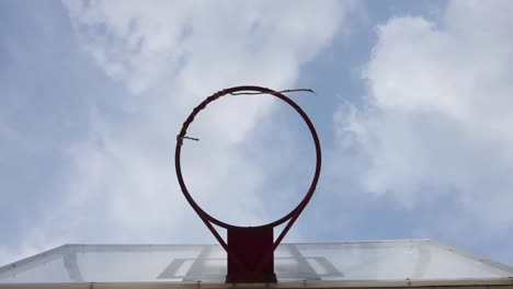 a basketball hoop with moving cloud background