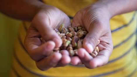 child holding pistachios