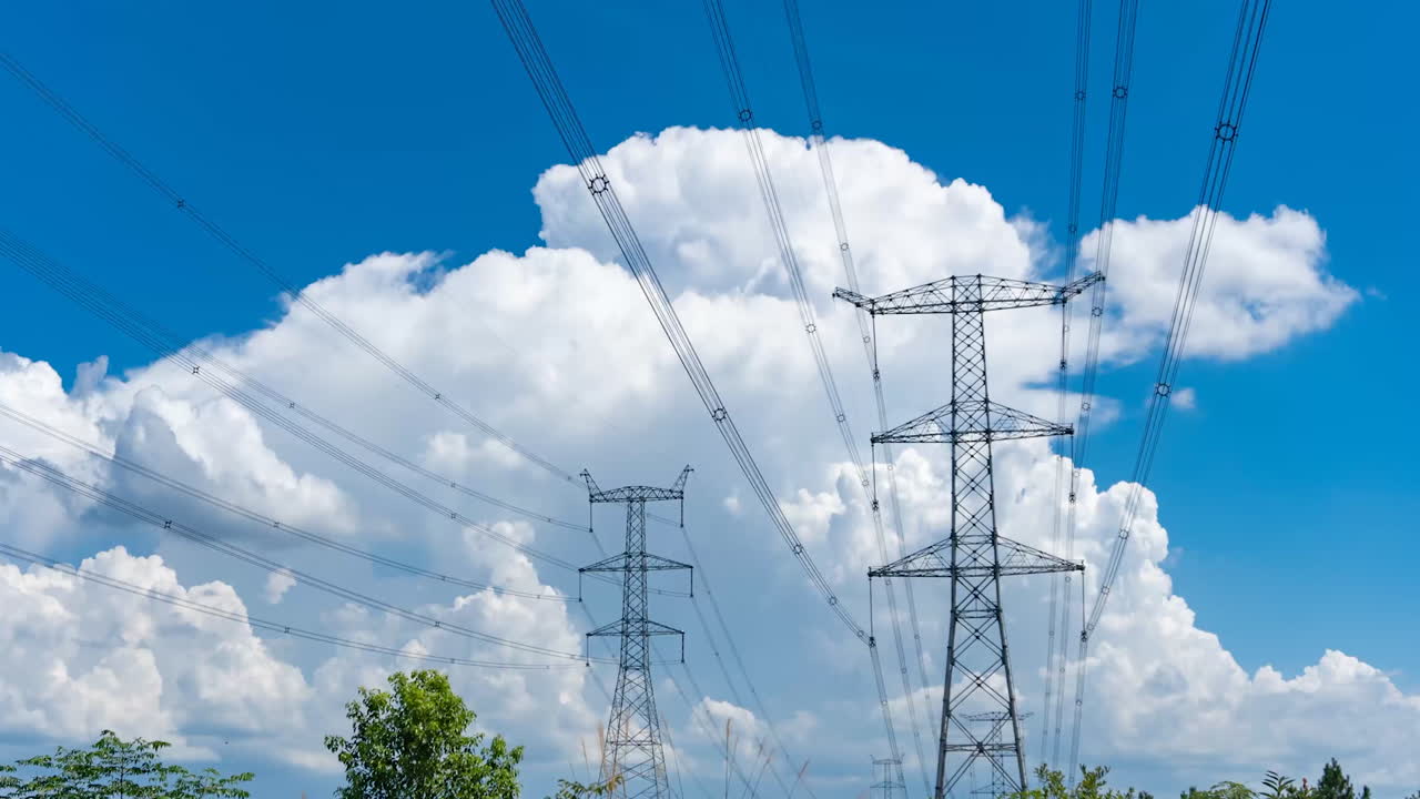 Time Lapse Of Clouds Above Electricity Pylon Of Electrical Power Transmission Line Under Blue Sky