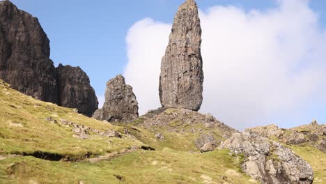 looking up at the giant rock pillars of old man of storr on a hike on isle of skye, highlands of scotland