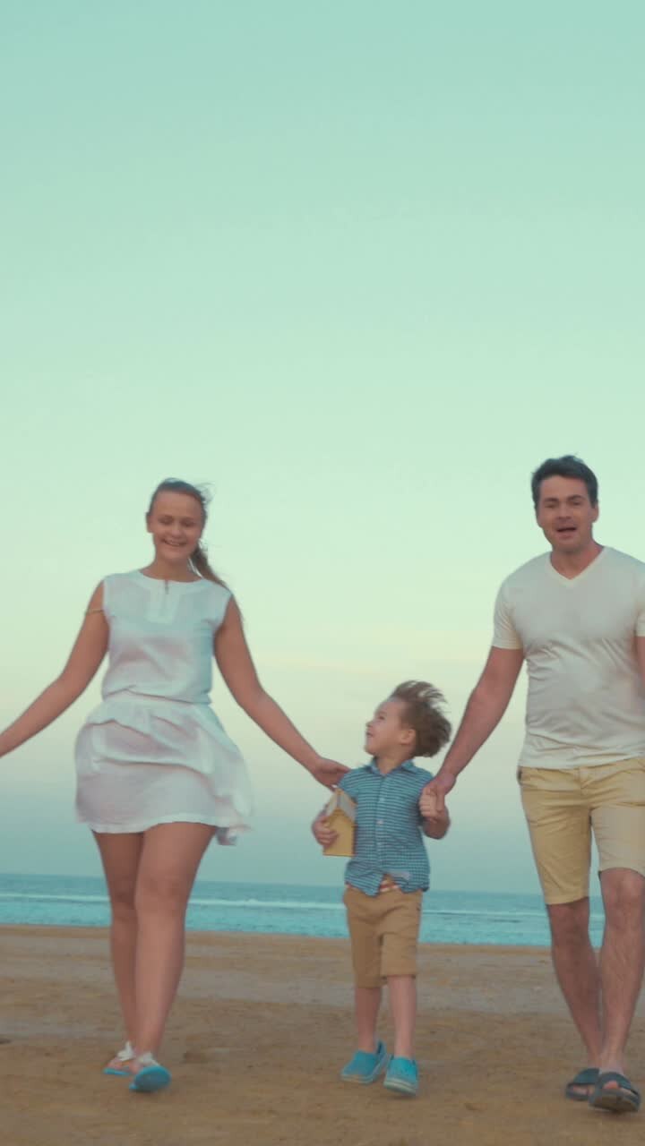 Happy family running on the beach