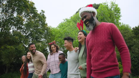 celebrating christmas outdoors, diverse family walking together and laughing in harmony