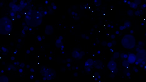 partículas de aspecto cinematográfico de color azul con movimiento de turbulencia moviéndose hacia la cámara con dof poco profundo en fondo negro