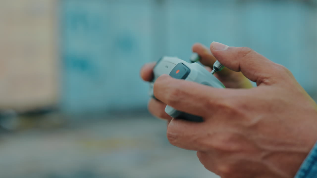 Person Operating a Drone Remote Control