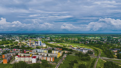 a beautiful aerial timelapse captures clouds moving across the sky above the european city of jelgava, latvia, showing its residential and industrial districts