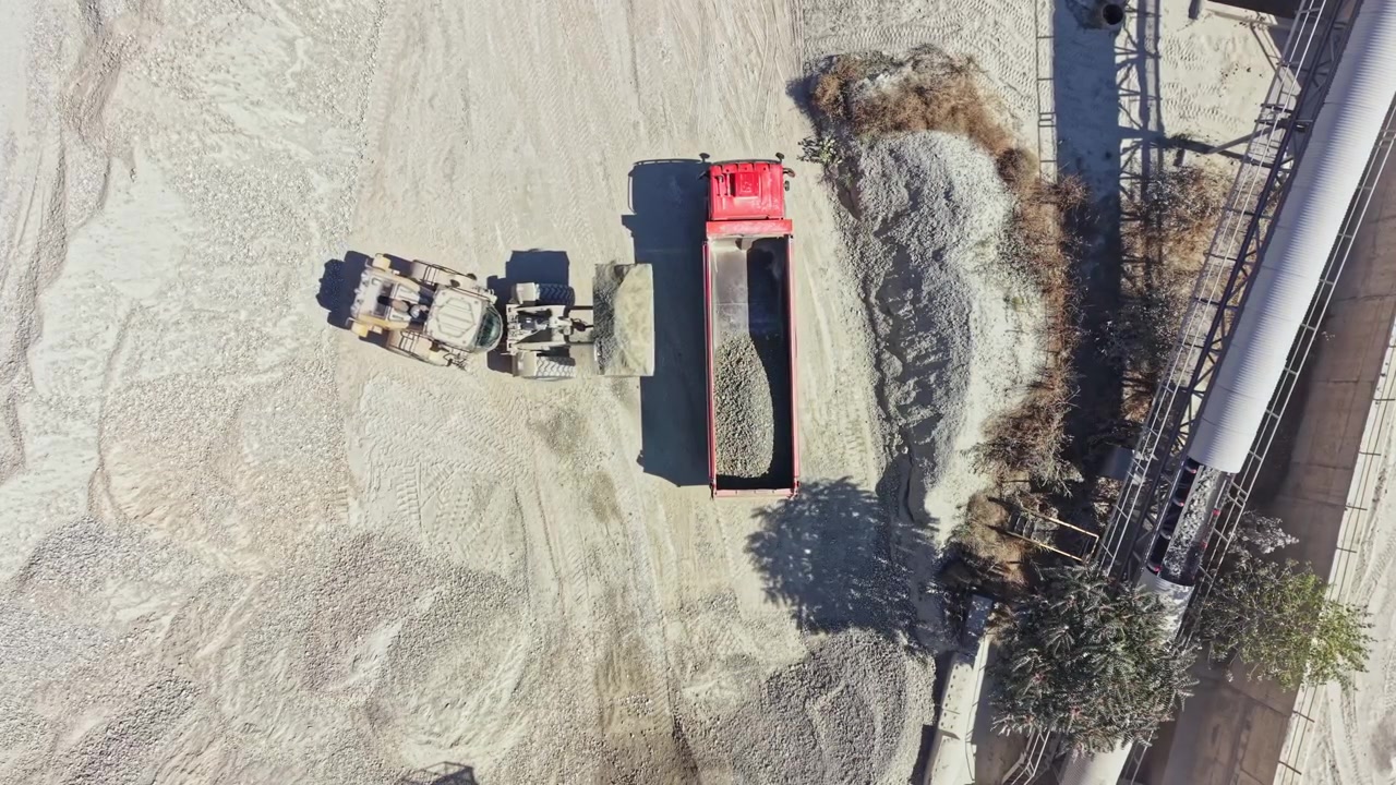Granite quarry operation with trucks and machinery at work