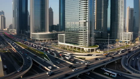 aerial view of a busy city highway interchange surrounded by skyscrapers