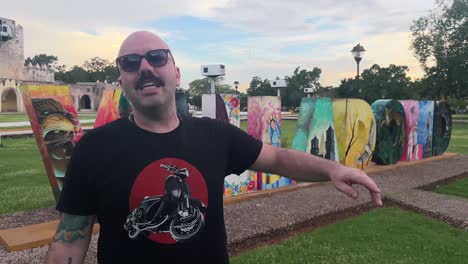 caucasian volger famous influencer talk in front of camera with valladolid sign in background yucatan mexico