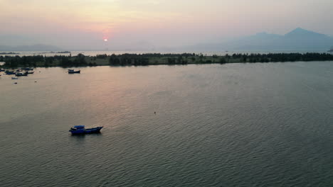 Sun-Sets-Over-Da-Nang-Bay-With-Hai-Van-Pass-Visible-On-The-Horizon-In-Central-Vietnam