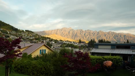 small town houses with sunlit remarkables mountain range in distance