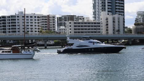 two boats passing by in a city harbor