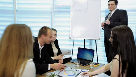 business people analyzing statistics. team of business people in meeting in a modern office boardroom