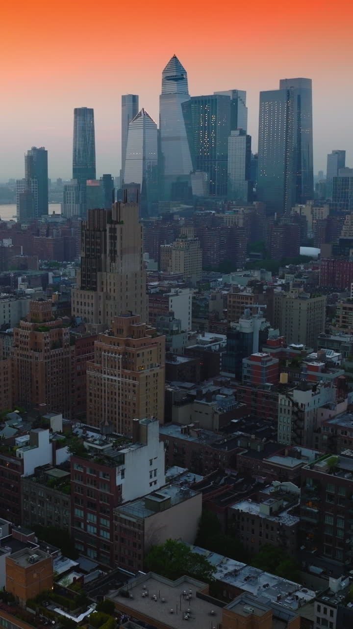 Unbelievable panorama of stunning New York architecture against beautiful orange sky. Metropolis at backdrop. Top view. Vertical video