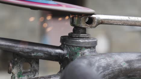 sparks flying from a metal grinding machine working on fixing an old bicycle