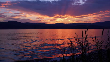 sunset over a lake with mountains