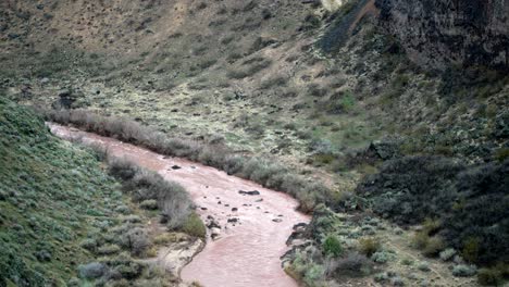 the red dirty muddy water of the virgin river in southern utah - static