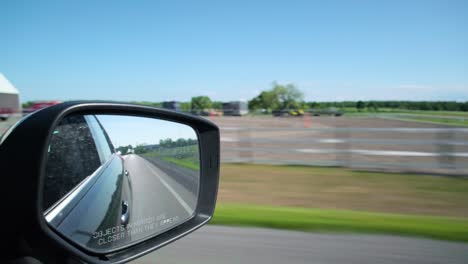 view from the side mirror to the dash view from a moving car in prince edward county