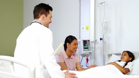 mother comforting a daughter and talking to doctor