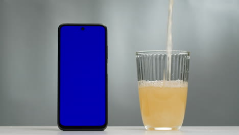 rose orange or white wine bottle and glass with chroma key green screen phone smartphone, application app, pouring of ecological natural wine. cheers, hands with wine glasses, drinking alcohol.
