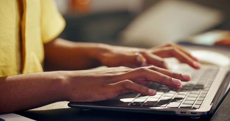 Close-up of Person Typing on Laptop Keyboard