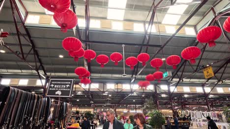 shoppers browse stalls under red lanterns