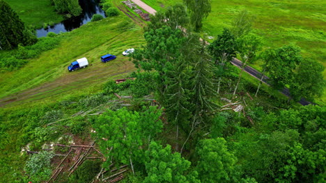 Deforestation-and-clearing-of-land-of-wood-used-to-build-log-cabins,-aerial